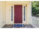Inviting entryway showcasing a red front door, sidelights, and patterned tile on the porch at 346 Gray Oak Dr, Tarpon Springs, FL 34689