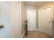 Bright hallway with multiple white doors and wood flooring, enhanced by tasteful decor and natural light at 346 Gray Oak Dr, Tarpon Springs, FL 34689
