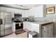 Modern kitchen featuring stainless steel appliances, white cabinets, and a stylish backsplash at 346 Gray Oak Dr, Tarpon Springs, FL 34689