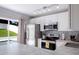 Bright kitchen features granite countertops, stainless appliances, and a view of the pool at 346 Gray Oak Dr, Tarpon Springs, FL 34689