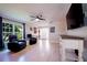 Airy living room featuring hardwood floors, modern ceiling fan, and open view into the entryway at 346 Gray Oak Dr, Tarpon Springs, FL 34689