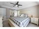 Relaxing main bedroom with a ceiling fan and stylish ensuite bathroom with a sliding barn door at 346 Gray Oak Dr, Tarpon Springs, FL 34689