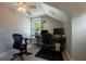 Home office featuring two work spaces, multiple monitors, and a ceiling fan and window at 346 Gray Oak Dr, Tarpon Springs, FL 34689