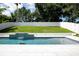 Backyard pool area with a manicured lawn and privacy fence at 346 Gray Oak Dr, Tarpon Springs, FL 34689