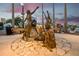 Bronze sculpture of a group of women in a park setting at dusk, creating a peaceful scene at 346 Gray Oak Dr, Tarpon Springs, FL 34689