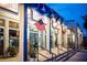 View of the shops along the street with American flags and stairs to the stores at 346 Gray Oak Dr, Tarpon Springs, FL 34689