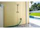 Outdoor shower with fixtures and green hose at 346 Gray Oak Dr, Tarpon Springs, FL 34689
