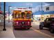 Street view of a trolley in Dunedin with shops and restaurants in the background at 346 Gray Oak Dr, Tarpon Springs, FL 34689