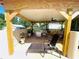 A comfortable lounge chair and hammock are found on the covered patio at 3501 Pine Top Dr, Valrico, FL 33594
