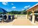 A relaxing outdoor patio features a grill, seating, and a scenic view of the surrounding greenery at 3501 Pine Top Dr, Valrico, FL 33594