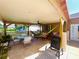 This covered back patio has a ceiling fan and furniture at 3501 Pine Top Dr, Valrico, FL 33594