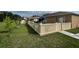 Spacious fenced backyard featuring a well-maintained lawn and a covered patio, perfect for outdoor entertaining at 3501 Pine Top Dr, Valrico, FL 33594