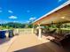 Backyard with covered patio, lounge chairs and outdoor furniture at 3501 Pine Top Dr, Valrico, FL 33594