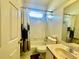 Bathroom with white tiled walls, a shower/tub combo and a single sink at 3501 Pine Top Dr, Valrico, FL 33594