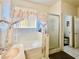 Bathroom featuring a bathtub, shower and sink with neutral colors and decorative curtains at 3501 Pine Top Dr, Valrico, FL 33594
