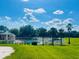 Gorgeous community pool and recreation area featuring a pool house, palm trees, and lush green lawn at 3501 Pine Top Dr, Valrico, FL 33594