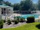 Community pool features a white fence for safety, ample seating, and is surrounded by lush landscaping at 3501 Pine Top Dr, Valrico, FL 33594