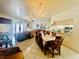 Open-concept dining area next to the living room with tile flooring and a chandelier at 3501 Pine Top Dr, Valrico, FL 33594
