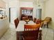 Bright dining room with a wooden table, chandelier, and glass-door china cabinet at 3501 Pine Top Dr, Valrico, FL 33594