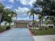Charming single-story home featuring a well-manicured lawn, complemented by lush tropical landscaping and a two car garage at 3501 Pine Top Dr, Valrico, FL 33594