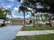 Charming single-story home featuring a well-manicured lawn, complemented by lush tropical landscaping and a two car garage at 3501 Pine Top Dr, Valrico, FL 33594