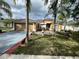 Charming single-story home featuring a well-manicured lawn, complemented by lush tropical landscaping and a two car garage at 3501 Pine Top Dr, Valrico, FL 33594