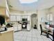 Well-lit kitchen featuring white cabinetry, stainless steel appliances, and a breakfast nook at 3501 Pine Top Dr, Valrico, FL 33594