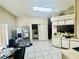 Spacious kitchen with stainless steel refrigerator and a dining table at 3501 Pine Top Dr, Valrico, FL 33594