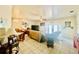 Cozy living room with tile flooring, ceiling fan, and a view of the outdoor patio through glass doors at 3501 Pine Top Dr, Valrico, FL 33594