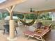Relaxing covered patio with comfortable seating, ceiling fan, and beautiful wooden beams, ideal for outdoor enjoyment at 3501 Pine Top Dr, Valrico, FL 33594