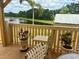 Scenic patio view overlooking a serene lake, enhanced by potted plants and a charming outdoor seating area at 3501 Pine Top Dr, Valrico, FL 33594