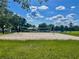 Community sand volleyball court, surrounded by green grass, offering a fun recreational activity for residents at 3501 Pine Top Dr, Valrico, FL 33594