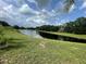 A serene water view showcasing lush greenery and clear skies, ideal for a tranquil lifestyle at 3501 Pine Top Dr, Valrico, FL 33594