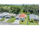 Aerial view of a cozy home with a carport and lush green surroundings at 36731 Tara Ave, Zephyrhills, FL 33542