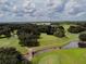 Aerial view of the scenic golf course features lush green fairways, mature trees, and winding water hazards at 36731 Tara Ave, Zephyrhills, FL 33542