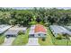 Aerial view of a cozy home with a carport and lush green surroundings at 36731 Tara Ave, Zephyrhills, FL 33542