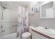 The bathroom is decorated with ocean themed decor with a tub and shower combination behind a seashell curtain at 36731 Tara Ave, Zephyrhills, FL 33542