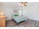 Inviting bedroom featuring a bed, dresser, ceiling fan, and plank flooring at 36731 Tara Ave, Zephyrhills, FL 33542