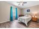 Neutral bedroom with wood floors, ceiling fan, and a bright window offers a relaxing space at 36731 Tara Ave, Zephyrhills, FL 33542