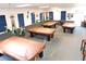 Spacious billiard room with multiple tables, overhead lighting, and comfortable seating at 36731 Tara Ave, Zephyrhills, FL 33542