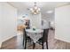 Open dining area with modern floors and decorative chandelier next to the kitchen at 36731 Tara Ave, Zephyrhills, FL 33542
