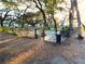 A quaint dog park surrounded by beautiful mature trees and a secure fence for your furry friends at 36731 Tara Ave, Zephyrhills, FL 33542