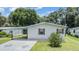 Attractive single-story home boasting a carport, green lawn, and beautiful landscaping at 36731 Tara Ave, Zephyrhills, FL 33542