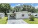 Charming single-story home with a carport, green lawn, and inviting curb appeal at 36731 Tara Ave, Zephyrhills, FL 33542