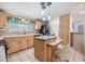 Charming kitchen with island, stainless steel appliances, and tiled backsplash at 36731 Tara Ave, Zephyrhills, FL 33542
