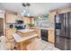 Updated kitchen featuring island, modern appliances, and tiled floors at 36731 Tara Ave, Zephyrhills, FL 33542