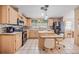 Bright kitchen with island, stainless steel appliances, and tiled floors at 36731 Tara Ave, Zephyrhills, FL 33542