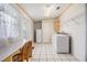 Bright laundry room with white appliances, tile floor, and convenient desk area at 36731 Tara Ave, Zephyrhills, FL 33542