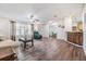 Spacious living room with laminate wood flooring, ceiling fan, and comfortable seating arrangement at 36731 Tara Ave, Zephyrhills, FL 33542