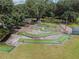 Aerial view showcasing the community's fun mini-golf course surrounded by mature trees at 36731 Tara Ave, Zephyrhills, FL 33542